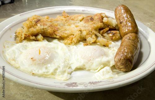 Photo: fried eggs over easy pork sausages home fried potatoes breakfast fried eggs over easy pork sausages home fried potatoes breakfast