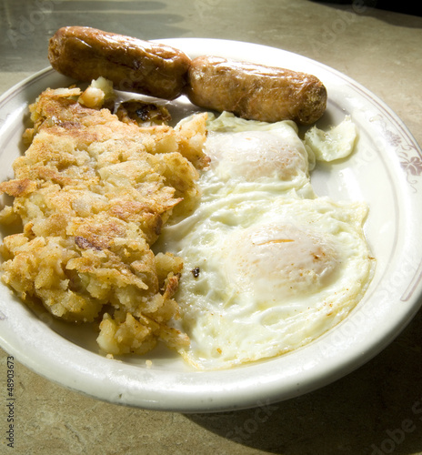 Photo: fried eggs over easy pork sausages home fried potatoes breakfast fried eggs over easy pork sausages home fried potatoes breakfast