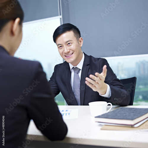Photo: asian business people talking in office asian business people talking in office