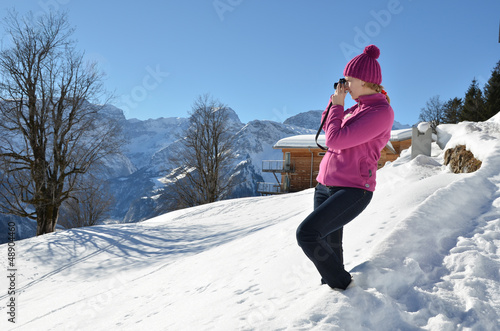 Photo: Girl taking a photo in the Swiss Alps Girl taking a photo in the Swiss Alps