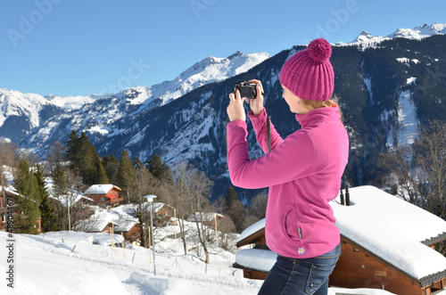 Photo: Girl taking a photo in the Swiss Alps Girl taking a photo in the Swiss Alps
