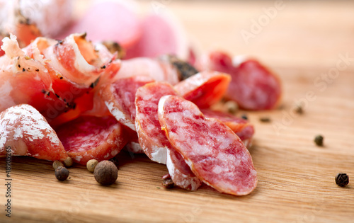 Photo: Sausage. Dried Smoked Sausages Sliced on Board Sausage. Dried Smoked Sausages Sliced on Board