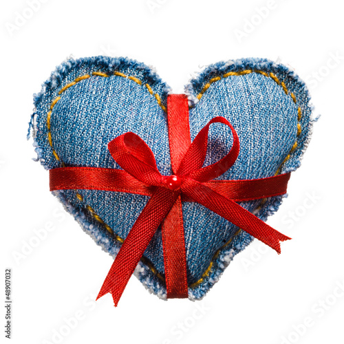 Photo: Valentine jeans heart with red holiday ribbon. Isolated on white Valentine jeans heart with red holiday ribbon. Isolated on white