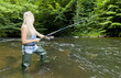woman fishing in river