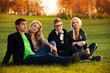 Photo: Four students sitting on the loan Four students sitting on the loan