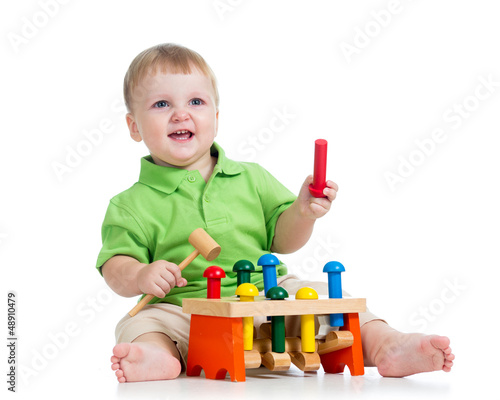 Photo: kid playing toy isolated on white background kid playing toy isolated on white background