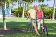 Happy Senior Couple on Bicycles In Green Park