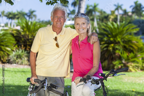 Photo: Happy Senior Couple on Bicycles In Park Happy Senior Couple on Bicycles In Park