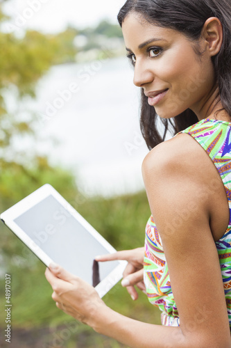 Photo: Mixed Race Latina Woman Using Tablet Computer Mixed Race Latina Woman Using Tablet Computer