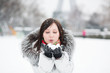 Photo: Beautiful young girl blowing on snow Beautiful young girl blowing on snow