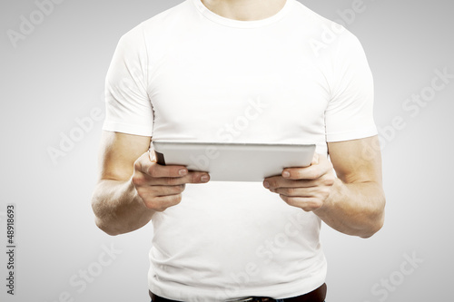 Photo: man holding touch pad man holding touch pad