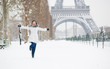 Winter in Paris. Happy young girl jumping