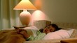 Video: Little girl lies in bed with eyes open at background of lamp Little girl lies in bed with eyes open at background of lamp