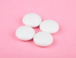 white pill on pink background