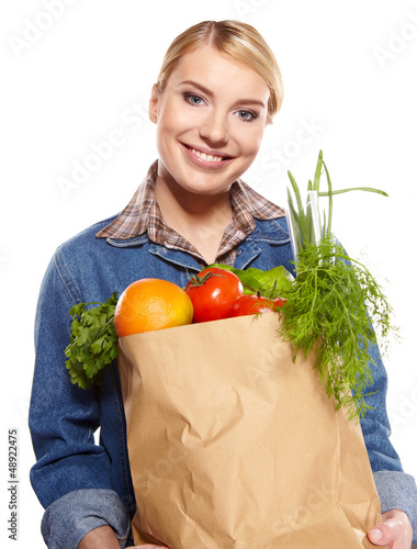Photo: woman holding a bag full of healthy food. shopping . woman holding a bag full of healthy food. shopping .