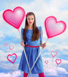 Beautiful woman holding  two hearts over a sky background