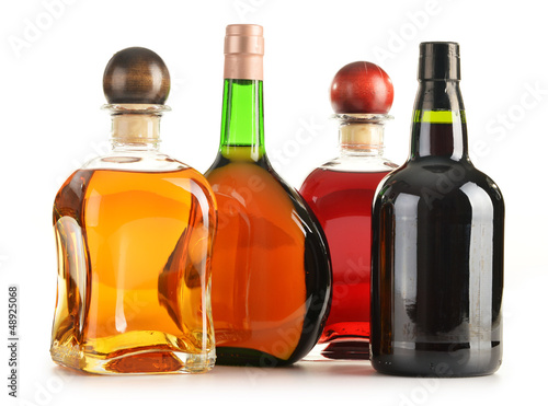 Photo: Composition with bottles of assorted alcoholic products isolated Composition with bottles of assorted alcoholic products isolated