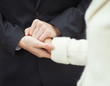Zdjęcie: A groom squeezeing bride's hand A groom squeezeing bride's hand