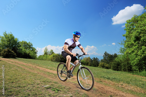 Photo: Person riding a bicycle Person riding a bicycle