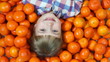 Girl lying in orange. Looking at camera
