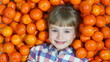 Girl lying in orange. Looking at the camera
