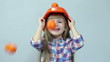 Orange rain. At the head of child falling tangerines