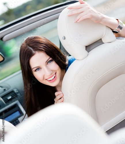 Photo: Portrait of pretty woman sitting in the car Portrait of pretty woman sitting in the car