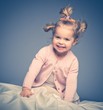 Photo: Little girl having fun on bed Little girl having fun on bed