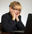 Stressed female executive hands on face looking at computer