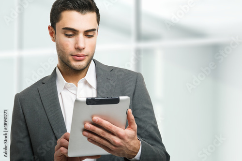 Photo: Man using his tablet computer Man using his tablet computer