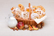 Sweet cakes in basket, fruit and milk decoration