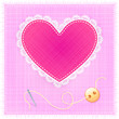 Red heart with lace, needle and button on fabric background