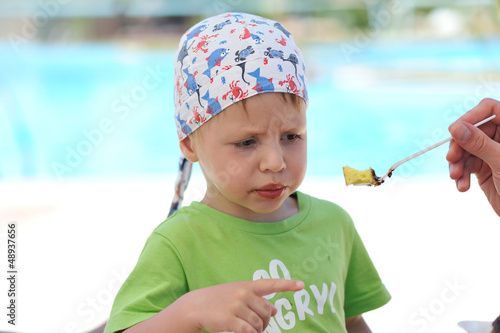 Photo: Father feeding son delicious dessert spoon Father feeding son delicious dessert spoon