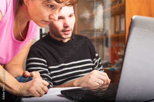 Photo: People looking at laptop People looking at laptop