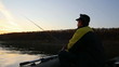 man fishes with spinning at sunset 