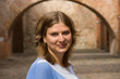Portrait of a woman against a brick arch