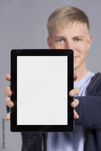 Photo: Joyful man presenting tablet. Joyful man presenting tablet.