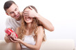 man giving heart-shaped box  for his girlfriend