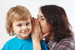Mother whispers something to her little son