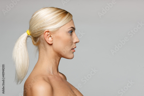 Photo: Side view closeup of beautiful blond woman looking forward Side view closeup of beautiful blond woman looking forward