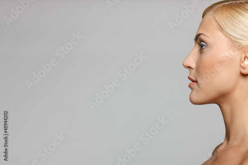 Photo: Cropped picture of side view closeup of blond woman Cropped picture of side view closeup of blond woman