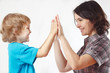 Mother playing with her little son on a white background