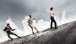 Three business people pulling rope