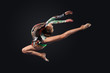 Young woman in gymnast suit posing