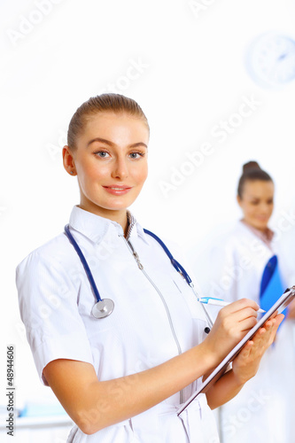 Photo: Young female doctor in white uniform Young female doctor in white uniform