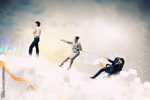 Photo: Three business people pulling rope Three business people pulling rope