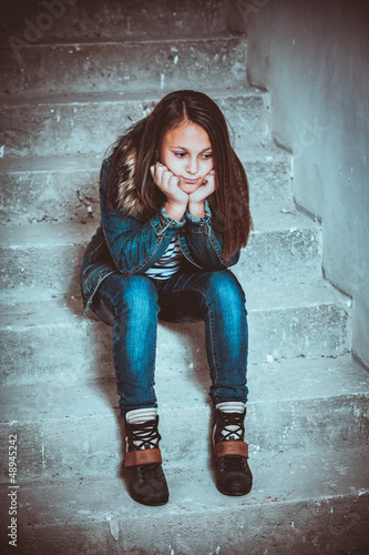 Photo: portrait of a sad teenage girl looking thoughtful about trouble portrait of a sad teenage girl looking thoughtful about trouble