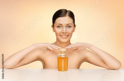 Photo: woman with oil bottle woman with oil bottle