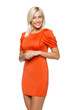 Young smiling woman in bright orange dress