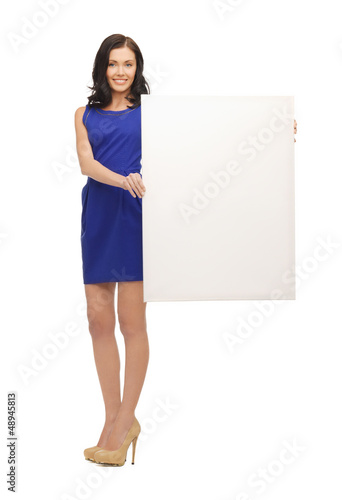 Photo: lovely woman in blue dress with blank board lovely woman in blue dress with blank board